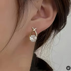 Stud earrings with golden cross and zirconia